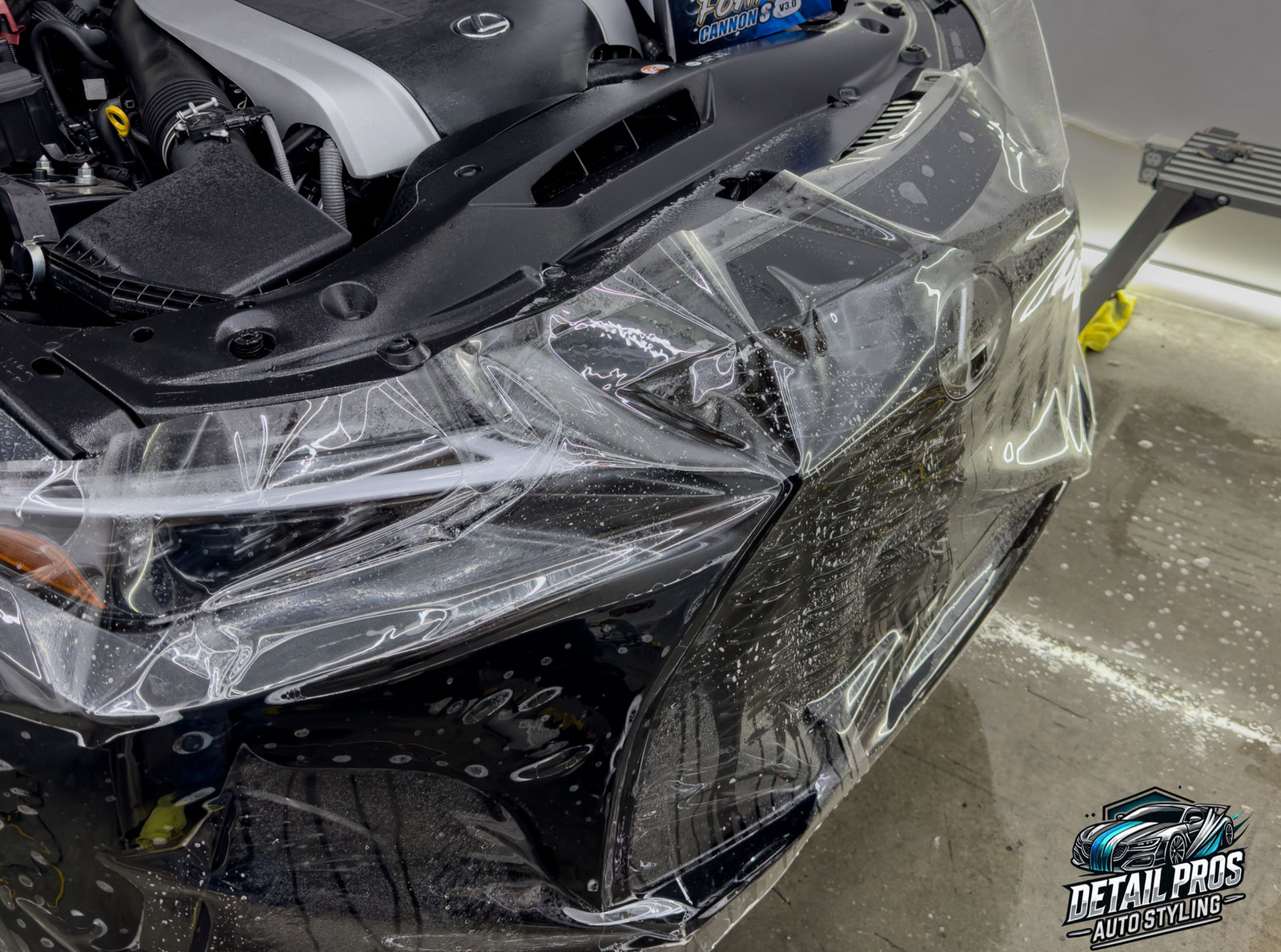 Clear paint protection film being fitted to a front bumper